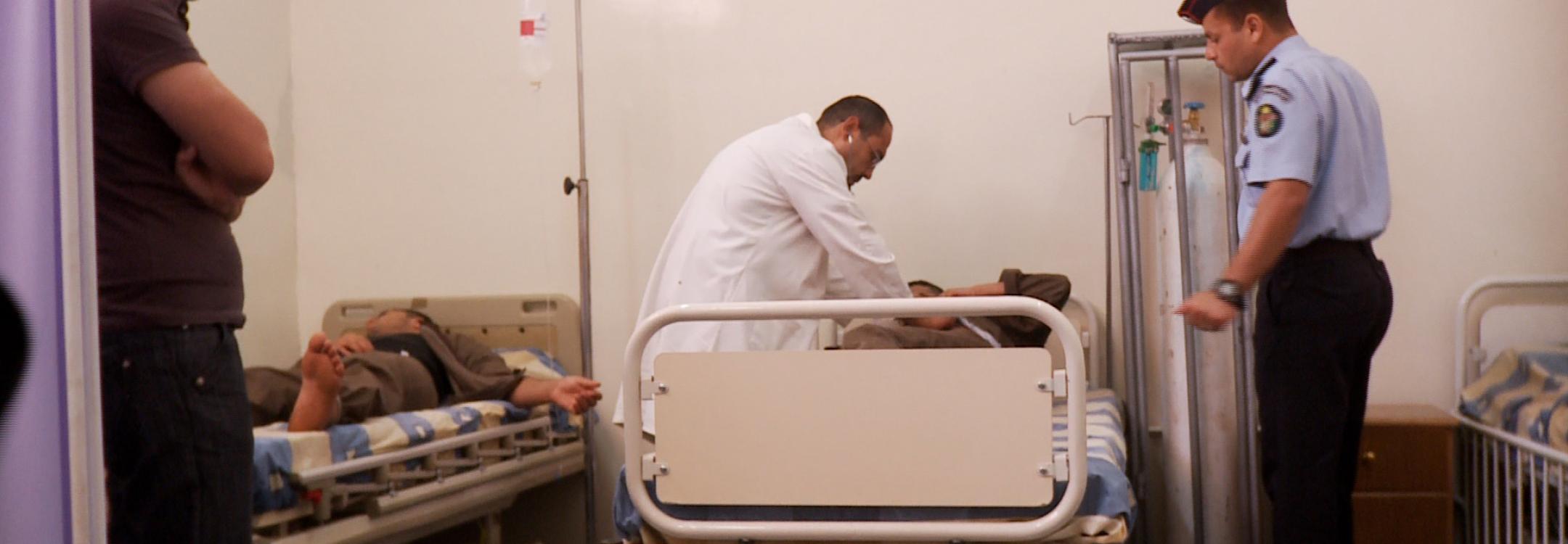 A detainee is treated by a doctor
